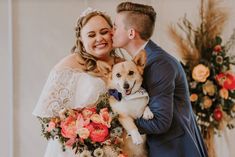 a bride and groom kissing with their dog