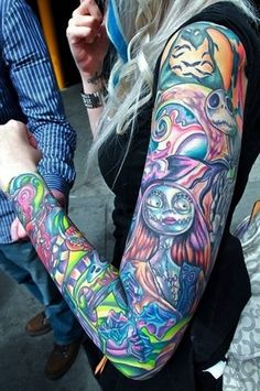 a woman with colorful tattoos on her arm