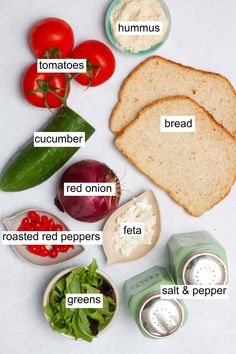 the contents of a sandwich on a white surface with tomatoes, lettuce, bread and other ingredients