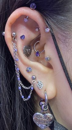 a woman with ear piercings and jewelry on her ears