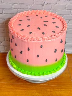 a watermelon cake sitting on top of a wooden table