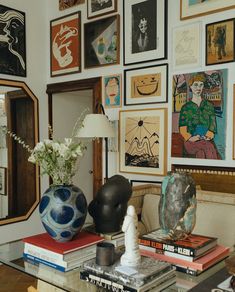 a living room filled with lots of art on the wall