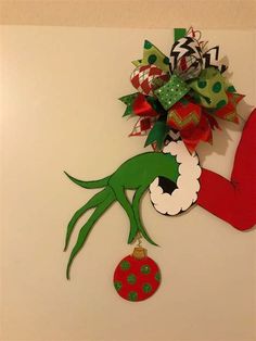 a christmas decoration made out of paper with the grin's head hanging from it