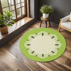 a living room with a large green rug on the floor and potted plants next to it