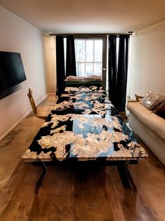 a long table with black and white designs on it in front of a large window