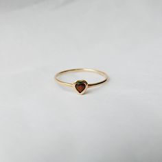 This Garnet Heart Ring brings love with you wherever you go. Show someone you love that you always have them in your heart. A great gift ring! Details: 14k gold (available in yellow, rose or white gold)Garnet heart measures about 3mm Free Shipping on Domestic Orders Materials: Garnet, 14k gold Need your ring bigger tha Garnet Heart Ring, Heart-shaped 14k Gold Ruby Promise Ring, Yellow Gold Heart Birthstone Promise Ring, 14k Gold Solitaire Heart Ring For Valentine's Day, 14k Gold Solitaire Heart Ring As Gift, Jewel Rings, Garnet Heart, Heart Rings, Gold Heart Ring