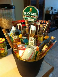 a bucket filled with lots of food and condiments on top of a table