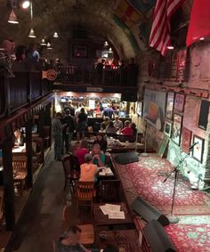 people are sitting at tables in an old building