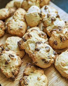 a wooden cutting board topped with lots of cookies