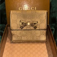 Gucci Beige/Gold Gg Canvas And Leather Princy Trifold Wallet Crafted From Gg Canvas And Leather, This Princy Trifold Wallet From Gucci Has An Eye Catching Style. It Is Designed To Neatly House All The Things You Need And Also To Deliver An Instantly Recognizable Look Of Luxury. Size: Height: 10 Cm, Width: 2 Cm, Length: 11 Cm Material: Leather This Item Is Pre-Loved With Lots Of Life Left. Classic Gucci Beige Wallet, Classic Beige Gucci Wallet, Elegant Beige Gucci Wallet, Gucci Wallets With Gold-tone Hardware For Formal Use, Gucci Wallet With Gold-tone Hardware For Formal Occasions, Gucci Wallets With Gold-tone Hardware For Formal Occasions, Designer Gucci Wallets With Gold-tone Hardware, Designer Gold Bifold Wallet, Gucci Bifold Evening Wallet