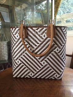 a brown and white bag sitting on top of a wooden table