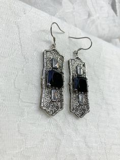 "Black Cubic Zirconia Earrings Square Peg Design#E63 Custom Made About 12 months ago I found a lovely Art Deco brooch and fell in love with the design. Fashioned in the design of the brooch, I now offer these lovely Antique reproduction earrings in sterling silver (matching pendant also available for sale in my store). The 3ct simulated black cubic zirconia gemstone is 10mm in L & W (3/8th\"). The 2 baguette CZ gems are 6mm x 3mm. The pendant is 1 3/4 inches long, it is just shy of 5/8th\" a Black Art Deco Earrings For Evening, Black Cubic Zirconia Earrings For Evening, Ornate Black Sterling Silver Jewelry, Black Filigree Earrings, Art Deco Silver Earrings With Cubic Zirconia, Art Deco Cubic Zirconia Earrings Gift, Silver Art Deco Drop Earrings, Elegant Antique Silver Earrings As Gift, Silver Art Deco Pierced Earrings