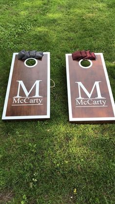 two cornhole game boards with the letters mca and mccary on them