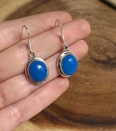 This listing is for one pair (2 earrings) of Blue Chalcedony Silver Lined Oval dangle 925 earrings. Chalcedony can be found translucent to opaque and in the colors of white, pink, blue, red or gray. Chalcedony is known to be a nurturing stone and helps to align the mind, body, and spirit. This stone is also known to dissipate negative energy and remove unwanted feelings of melancholia. Since Chalcedony is a good stone for balancing emotions, therefore, Chalcedony represents Balance & Removal of Blue Oval Cabochon Earrings As Gift, Sterling Silver Oval Cabochon Earrings Gift, Blue Oval Cabochon Earrings For Gift, Luxury Chalcedony Women's Earrings, Luxury Chalcedony Earrings For Women, Blue Cabochon Sterling Silver Earrings, Blue Chalcedony Dangle Jewelry, Blue Spiritual Nickel-free Earrings, Throat Chakra