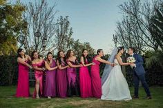 a bride and groom standing with their bridal party