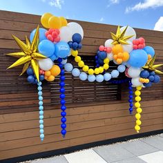 balloons and streamers are hanging from the side of a building