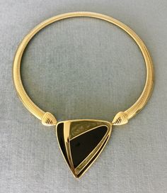 "You are looking at a truly exquisite VINTAGE TRIFARI MODERNIST, ART DECO STYLE, KUNIO MATSUMOTO ERA, BLACK and SILVER-COLOURED ENAMEL AND GOLD METAL OMEGA SNAKE CHAIN PENDANT COLLAR NECKLACE, SIGNED, Circa 1980's. THIS COLLAR NECKLACE IS EXTREMELY BOLD, EYE-CATCHING AND GORGEOUS SUPER RARE MINT, IN EXCELLENT, LIKE NEW CONDITION, IT HAS NEVER BEEN USED THIS NECKLACE WITH AN ART DECO INSPIRED BLACK AND SILVER ENAMEL STATION AND SUPER SHINY OMEGA CHAIN IS EXTRAORDINARILY BEAUTIFUL AND SCULPTURAL T Designer Metal Necklaces For Formal Occasions, Vintage Black Enamel Necklaces For Evening, Vintage Black Enamel Necklace For Evening, Vintage Black Enamel Necklaces For Formal Occasions, Vintage Black Enamel Necklace For Formal Occasions, Vintage Jewelry With Unique Design For Formal Occasions, Vintage Formal Jewelry With Unique Design, Modernist Art, Vintage Runway