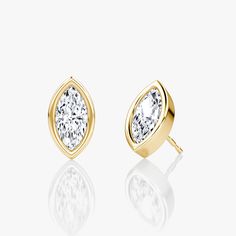 The Bezel Solitaire Studs combine vintage-inspired detail and modern appeal together for a look that’s timelessly elegant. Timeless Marquise Diamond Earrings For Formal Events, Timeless Marquise Diamond Earrings For Formal Occasions, Elegant Timeless Diamond Earrings For Anniversary, Classic Yellow Gold Earrings With Bezel Setting, Luxury Diamond Earrings With Timeless Design For Anniversary, Formal 14k Gold Earrings With Timeless Design, Timeless Gold Earrings With Bezel Setting, Modern Bezel Set Earrings For Formal Occasions, Modern Formal Earrings With Bezel Setting