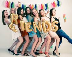 a group of young women standing next to each other with the word friends spelled out