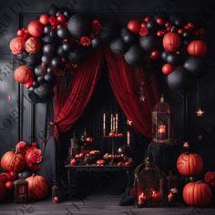 an image of a halloween party setting with balloons and pumpkins on the table in front of red drapes