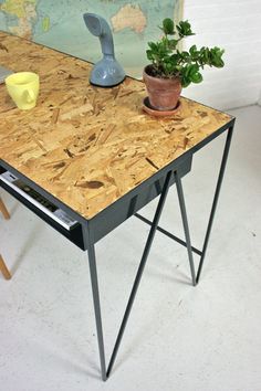 a wooden table with a plant on top