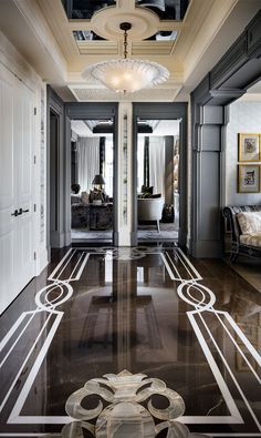 an elegant hallway with black and white marble flooring