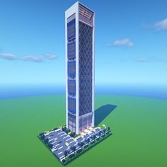 a very tall building sitting in the middle of a green field with lots of trees