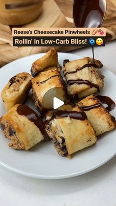 a white plate topped with rolls covered in chocolate