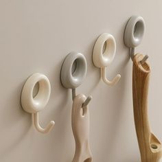 there are three hooks on the wall to hold cups