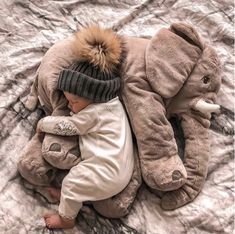 a baby is laying down with an elephant stuffed animal on it's back and the caption reads instagram