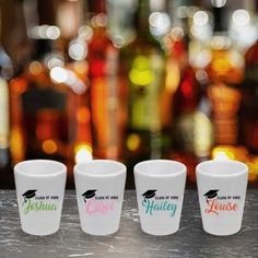 three shot glasses sitting on top of a counter