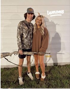 a man and woman standing next to each other in front of a white wall with the words lemons on it