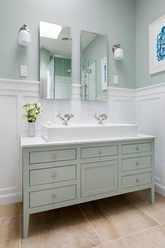 a bathroom with two sinks and three mirrors on the wall next to eachother