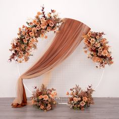 an arrangement of flowers and foliage is arranged on the wall for a wedding arch decoration