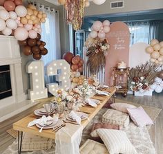 a table set up with balloons and decorations