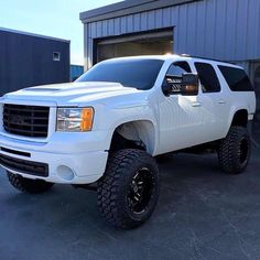 a white truck parked in front of a building