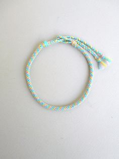 Pastel rainbow Pastel color anklet Kawaii anklet Kumihimo anklet Rope anklet Acrylic yarn Summer anklet Surfer gift Beach anklet Harajuku This braided anklet is made using pastel yellow,mint,baby blue and baby pink acrylic yarn. It is 0.15 inches/4 mm thick. The anklet will be secured to your ankle using a simple tie knot closure. Due to its acrylic yarn it is water resistant. Custom orders for different color combinations are welcome. Similar kumihimo anklet in my shop: https://www.etsy.com/lis Simple Tie Knot, Baby Pink Acrylics, Rope Anklet, Beaded Chocker, Harajuku Street Style, Kumihimo Patterns, Harajuku Street, Embroidery Bracelets, Summer Anklets