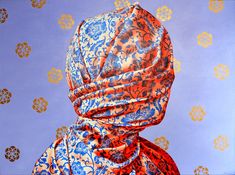 an orange and blue scarf draped over a person's head with circles in the background