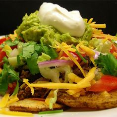 a white plate topped with tacos and guacamole