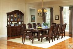 a dining room table with chairs and a china cabinet