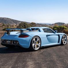 a blue sports car parked in a parking lot