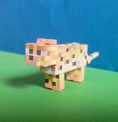 a paper model of a dog that is made out of colored blocks and pieces of wood