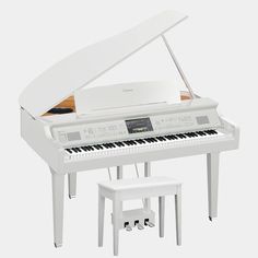 a white piano sitting next to a stool