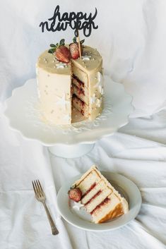 two slices of cake with strawberries on top and happy new year written on the side