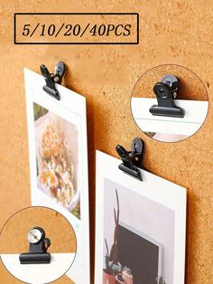 there are two pictures on the wall with clips to hang them in front of each other