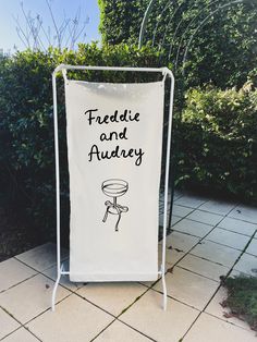 a white sign that says froddle and aurdy on the side of a sidewalk