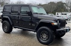 a black jeep parked in a parking lot