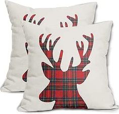 two pillows with red and black plaid deer heads on them