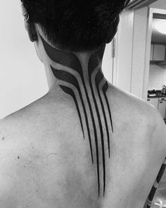 the back of a man's neck with black lines on his upper and lower part