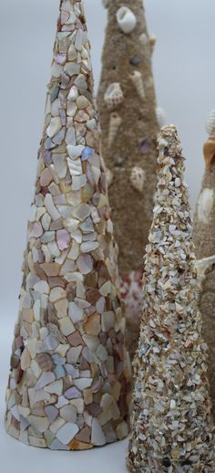 three small trees made out of shells and seashells